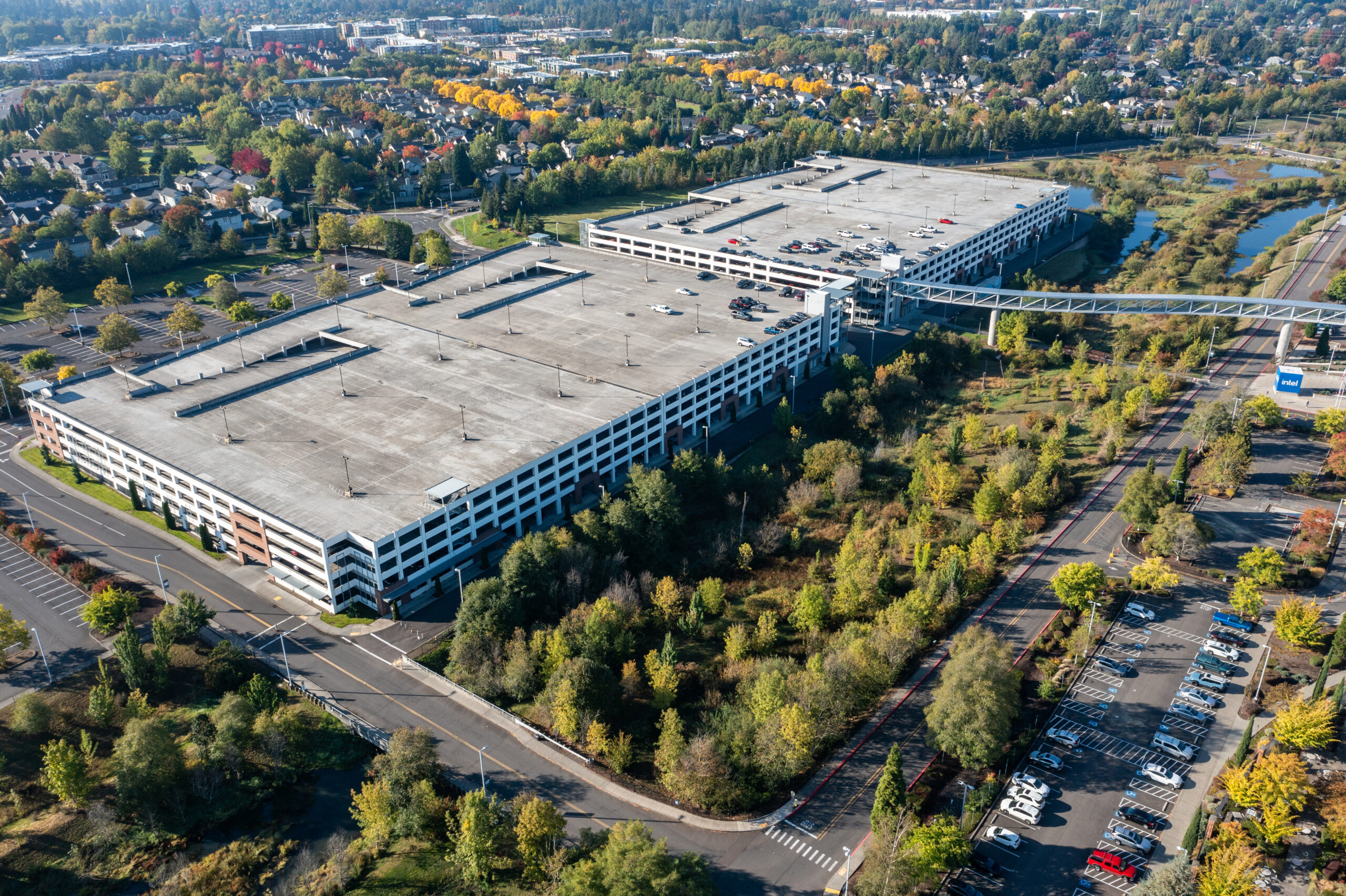 Hillsboro, OR, USA- October 6, 2024 - 4k Aerial drone photo of Intel's largest campus parking lot, captured during sunrise at fall season with blue sky. High quality picture for download.